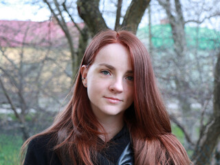 the girl with red hair in the park