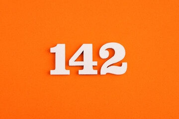 Number 142 - On orange foam rubber background