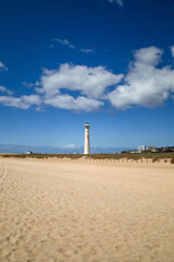 Fototapeta na wymiar the Jandia lighthouse behind the wide, fine sandy beach in southern Fuerteventura, Canary Islands, Spain