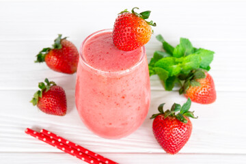 Strawberry yogurt fruit juice smoothie pink colorful fruit juice milkshake blend beverage healthy high protein the taste yummy In glass drink episode morning on white wood background.