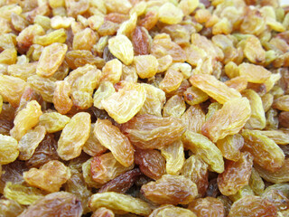     Texture of yellow and orange raisins. Dry raisins on the pile.                       