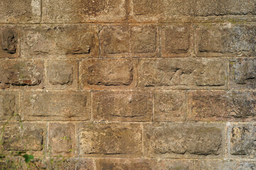 Large stone blocks forming a wall. They have an ocher color. Solid image suitable for background.