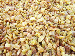        Texture of yellow and orange raisins. Dry raisins on the pile.                       