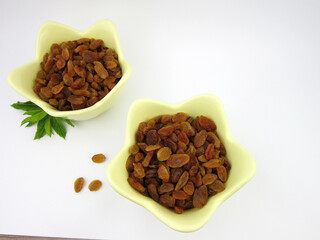     two bowls of yellow golden raisins              