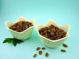   two bowls of yellow golden raisins                        