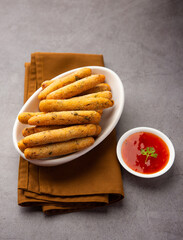 crispy Rava Aloo fingers or Potato semolina fried finger sticks served with ketchup
