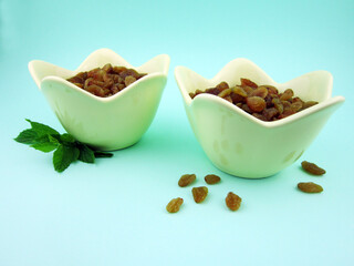     two bowls of yellow golden raisins                 