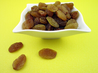      A bowl of yellow golden raisins 