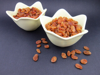    two bowls of yellow golden raisins          