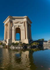 Fototapeta na wymiar triumphal arch and fountain in Montpellier france park in autum with clear sky royal park of Louis XIV