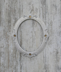 oval vintage frame on old white wooden wall