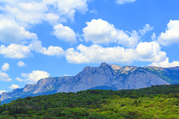 Obraz na płótnie Canvas The spurs of the rocky mountain Ai-Petri against the background of a cloudy sky.
