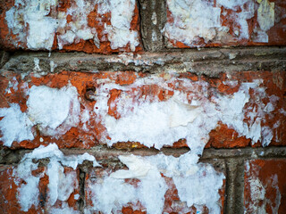 Abstract texture background. Brick wall with exposed bricks and old torn street posters. Design element
