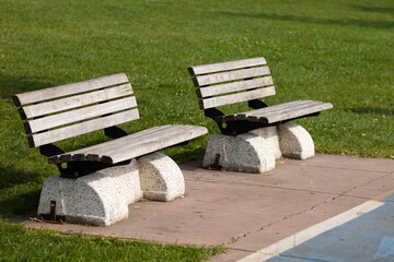 Wooden benches and chaise lounges for rest on the streets of the city and in the park, public places