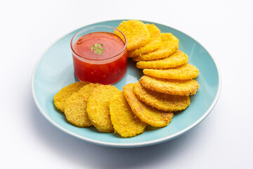 crispy potato rava fried slices or batatyache kaap or batata semolina fry snacks from India