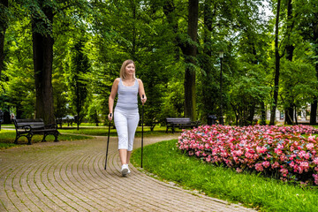 Nordic walking -  woman training in city park
 - obrazy, fototapety, plakaty
