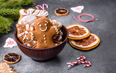 Gingerbread, Christmas tree decorations, dried citrus fruits on a gray concrete background