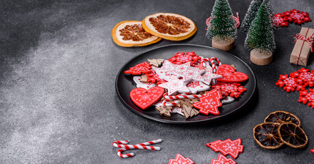 Gingerbread, Christmas tree decorations, dried citrus fruits on a gray concrete background