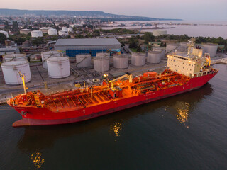 Aerial view of oil ship tanker and lpg ship at industrial port at sunset