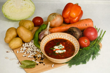 Traditional Ukrainian borscht with sour cream in a clay bowl.