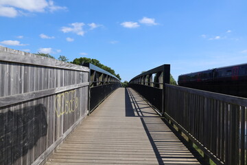 A metal bridge running over the bird sanctuary on the River Exe near Topsham in Devon, England