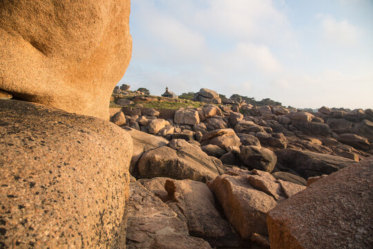 Extraordinarily beautifully colored stones and fantastically shaped rock formations weathered by centuries of wind and tide along the walking trail - the famous pink granite coast in Brittany, France