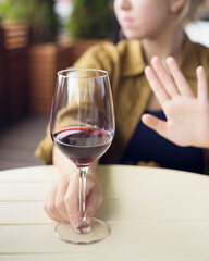girl refuses to drink wine, non-alcoholic concept, selective focus, blur
