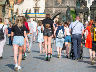 Back view with crowds of unidentified tourists people walking and strolling on the famous Charles Bridge in Prague.