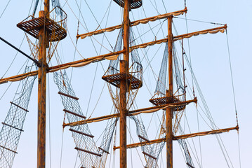 View of the masts with yardarms of a wooden ship. Tackle of a wooden sailboat - Mars baskets,...