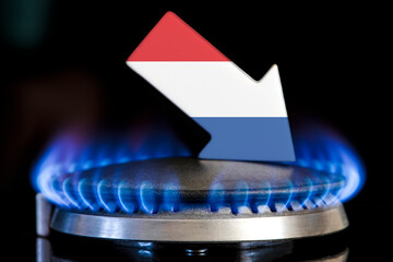 Decreased gas supplies in Netherlands. A gas stove with a burning flame and an arrow in the colors...