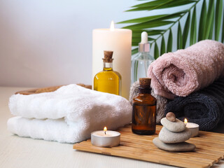Fototapeta na wymiar Massage oils, towels, candles. SPA