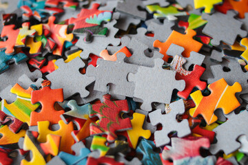 Multicolored puzzles. Family game. Concept of putting together disconnected elements. Puzzle background