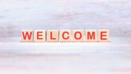 WELCOME word written on wooden blocks on a light background