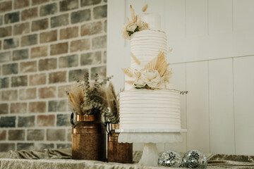 wedding cake with pampas and floral boho themed white