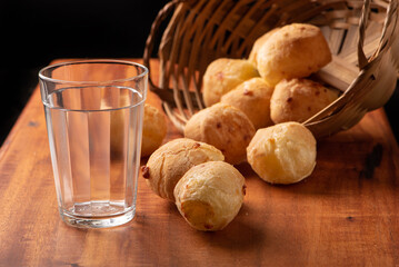 Cheese bread, beautiful cheese breads on rustic wood and an empty glass. selective focus.