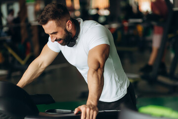 Fototapeta na wymiar Exhausted mid adult man on gym treadmill