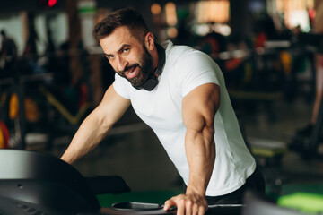 Fototapeta na wymiar Exhausted mid adult man on gym treadmill