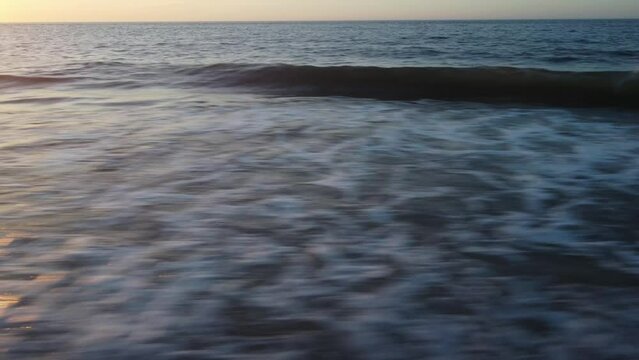 Beautiful view of vicious sea tides driven by a furious wind towards the Belmar Beach at sunset