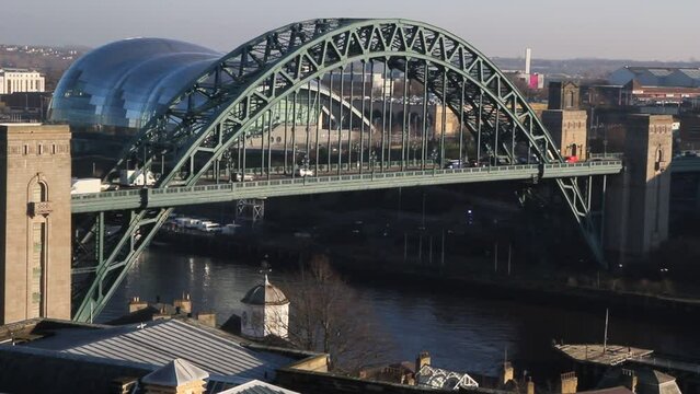 Traffic passing over the Tyne Bridge, Newcastle Upon Tyne, with the Sage Gateshead and Quayside in the background