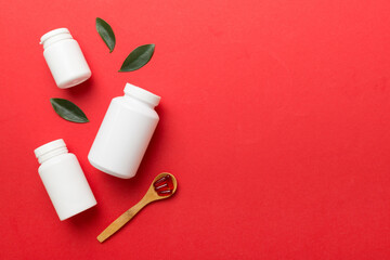 different drugs and health supplement pills with medicine bottle health care and medical top view. Vitamin tablets. Bottle with colored pills on table background. Multivitamins