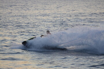 Jet ski driver drift on the sea . Spray from a jet ski.