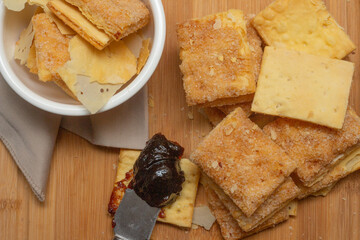 puff pastry cookies stacked near jam spoon