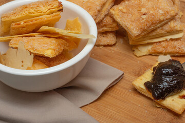 puff pastry cookies stacked near jam spoon