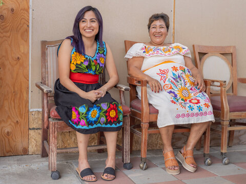 Portrait of an Indigenous woman and her daughter wearing tradtional clothing