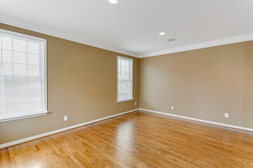empty room with window light brown wall hardwood floor recessed lights