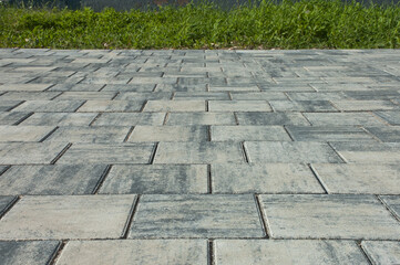 paving slabs, in the photo sidewalk decorative gray tiles close-up