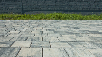 paving slabs, in the photo sidewalk decorative gray tiles close-up