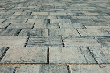 paving slabs, in the photo sidewalk decorative gray tiles close-up