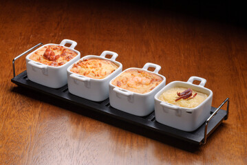 Traditional starters from Brazilian restaurants, known as escondidinho with octopus, cheese, shrimp and meat.