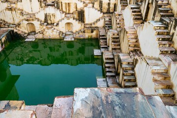 Beautiful shot of the Chand Baori or Abhaneri Step Well with reflection in the water,Rajasthan,India